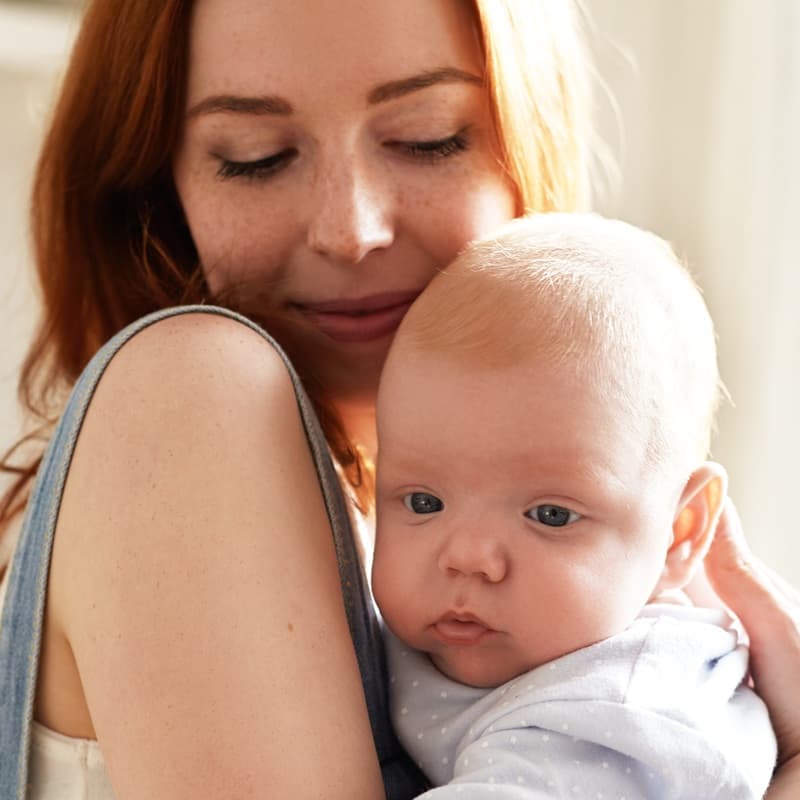 Mother holding her baby close